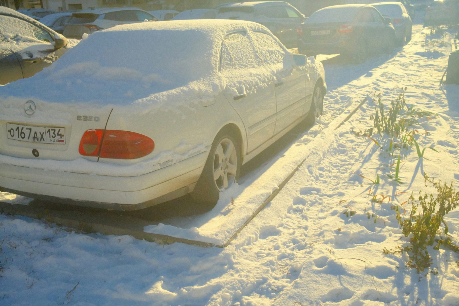 Snow-covered car parked outside a Rexburg apartment complex in winter