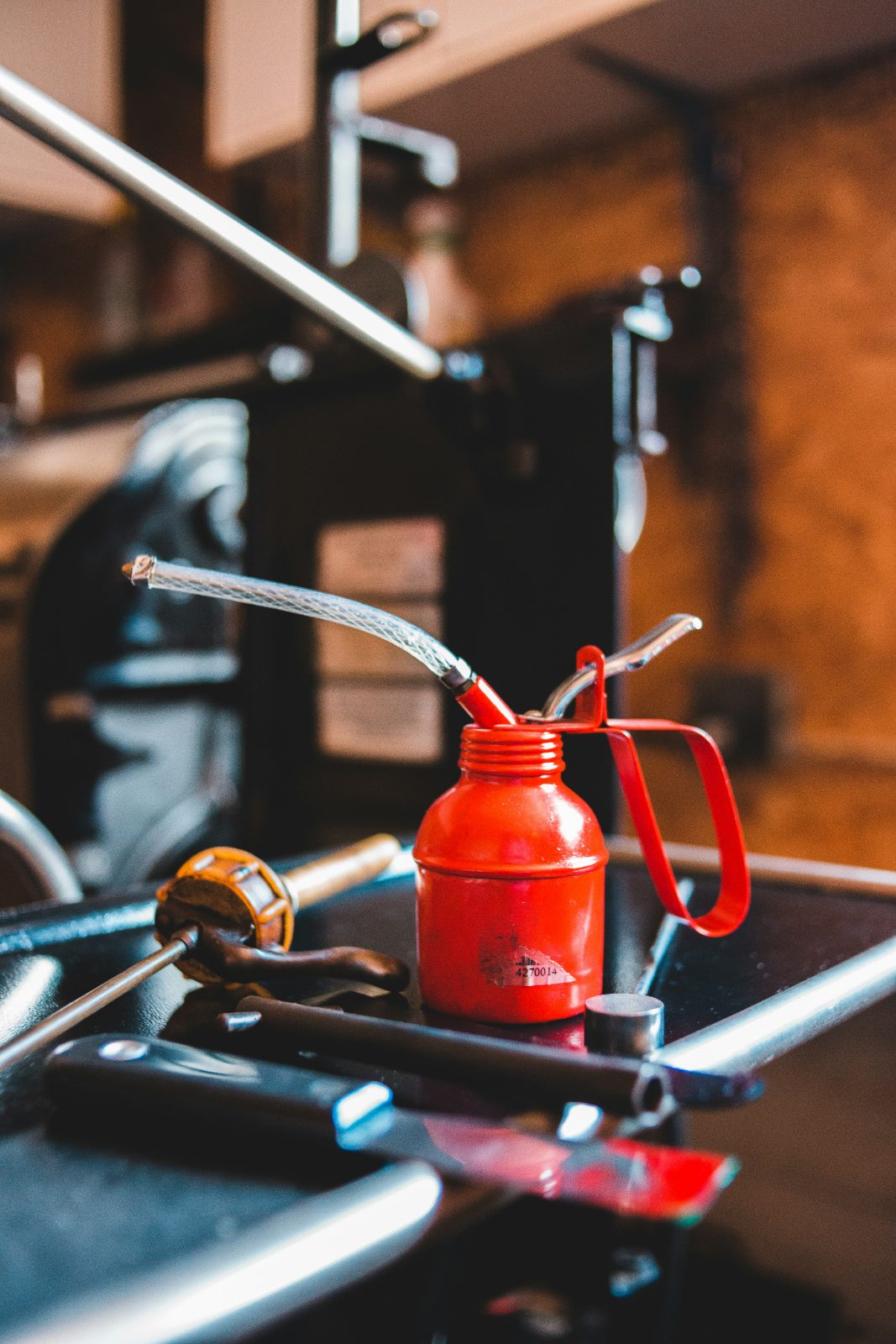 Oil can on a workbench — synthetic blend is the practical middle ground
