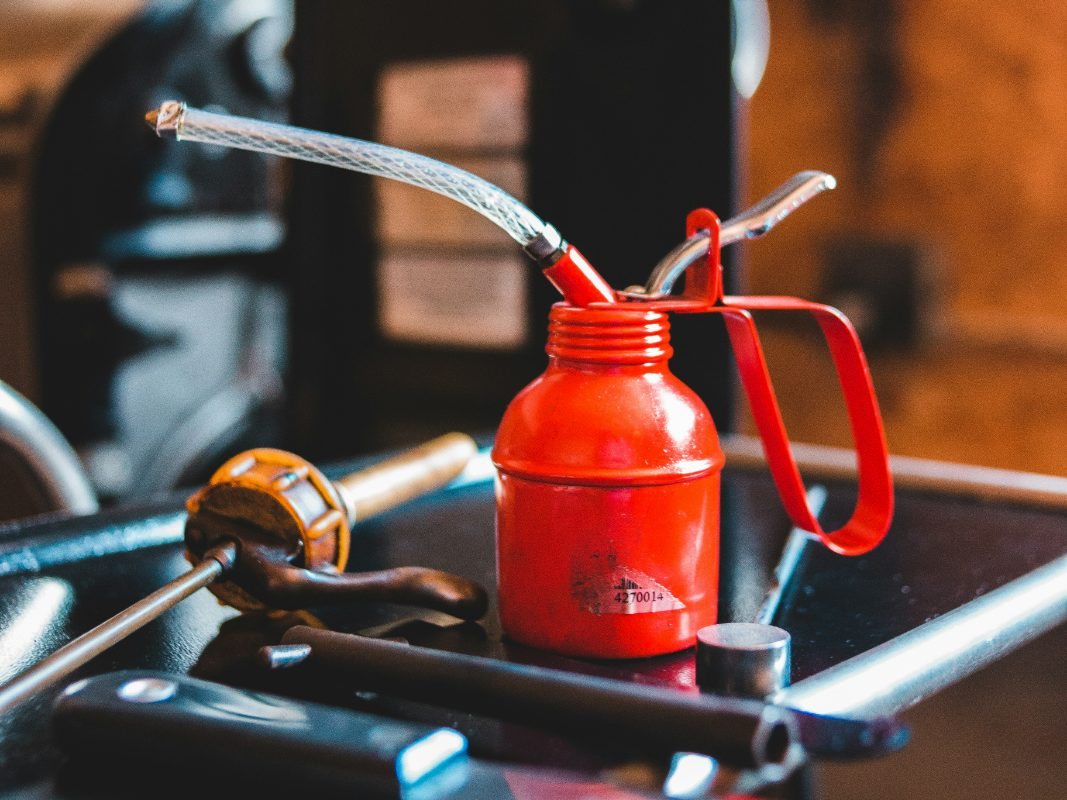 Red oil can on a workbench in the shop